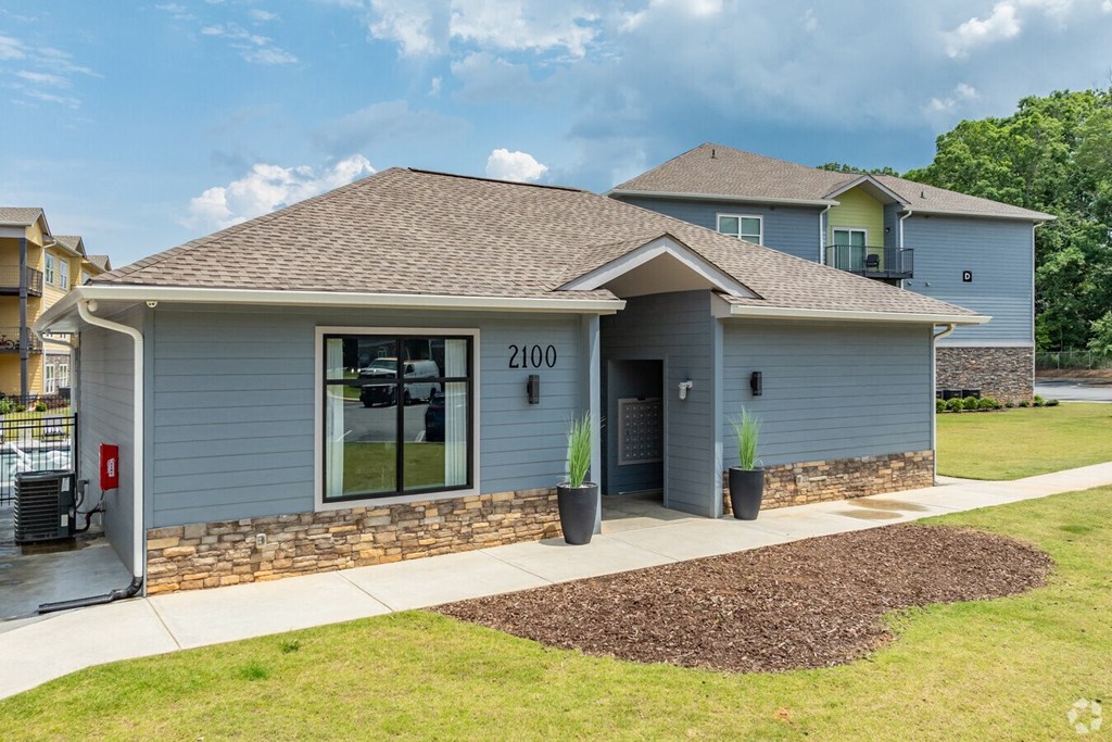 a blue house with a sidewalk in front of it