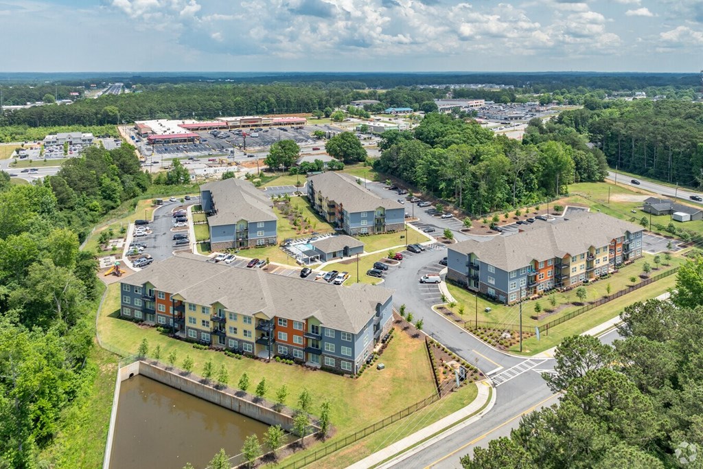 an aerial view of a city with buildings and a pond