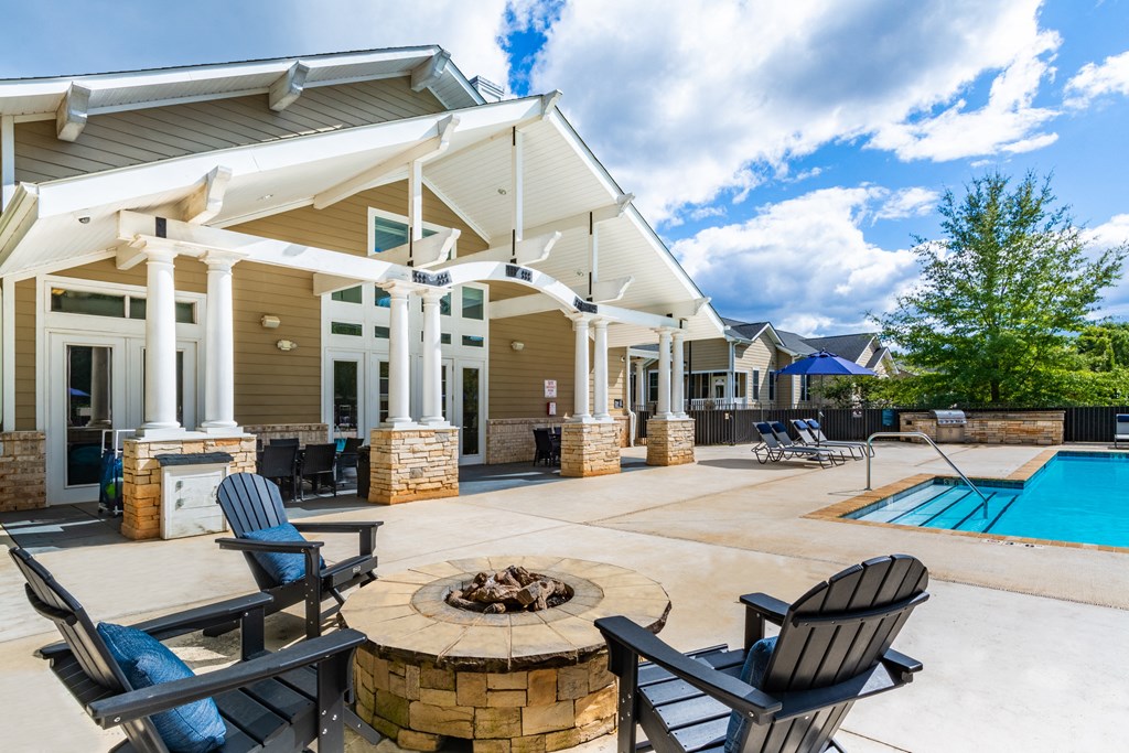 Clubhouse with a pool and a fire pit.