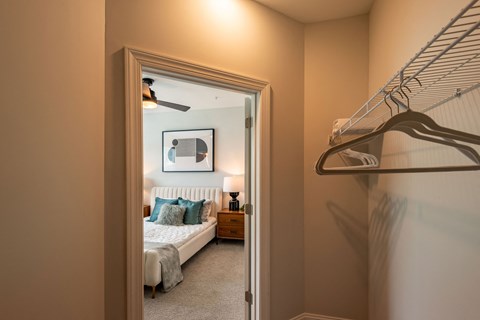 a bedroom with a bed and a closet with a mirrored closet door