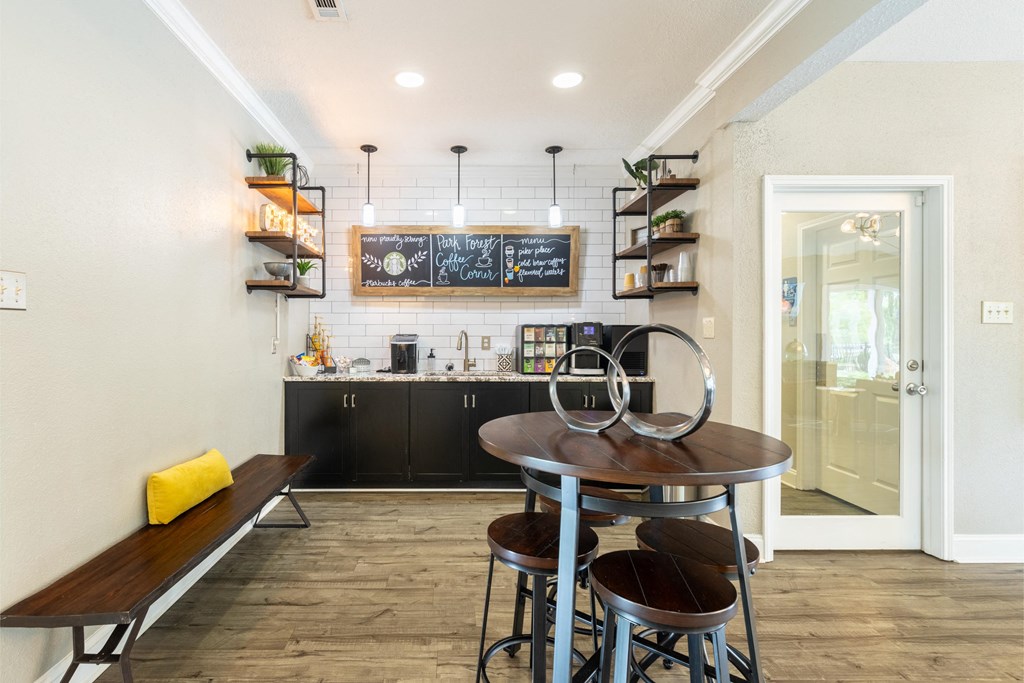 a kitchen and dining room with a table and chairs