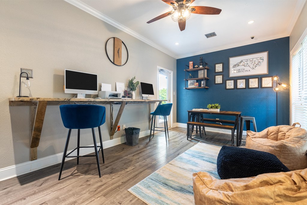 a home office with a computer desk and a couch