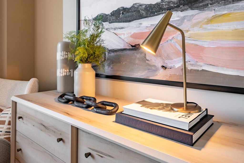 a desk with a lamp and a book on it