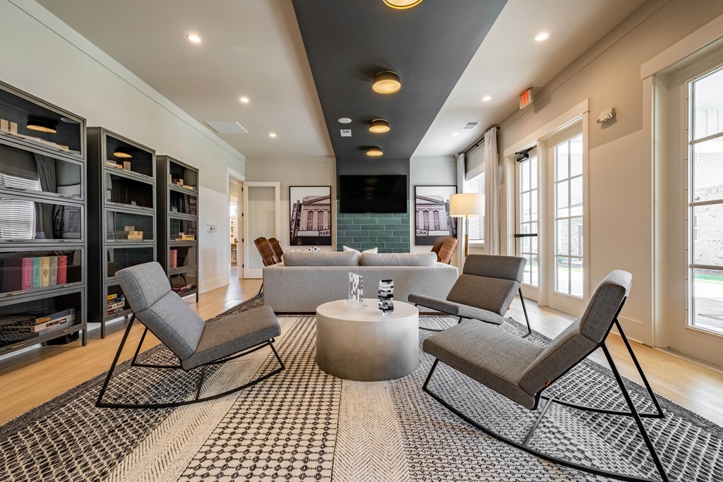 a living room with a couch and chairs and a table