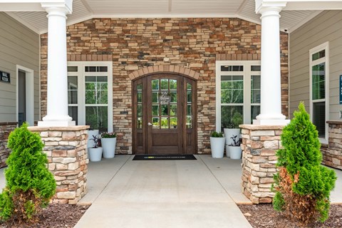 the front porch of a house with a wooden door