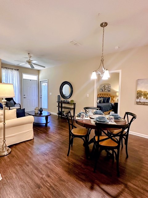 A dining room with a table set for six.