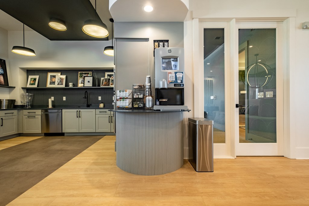 a reception area with a counter and glass doors