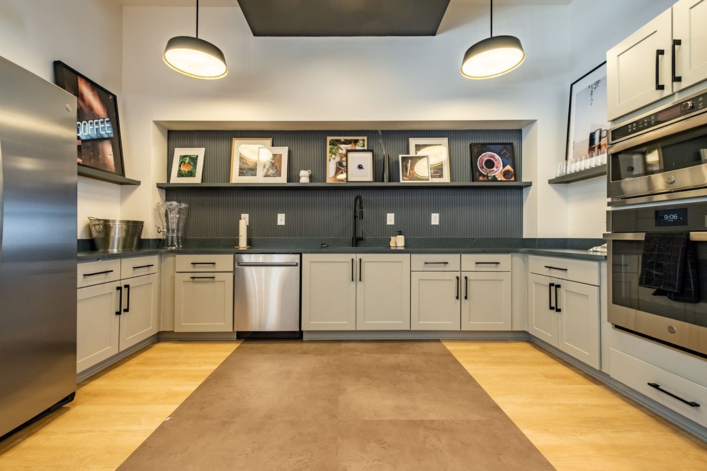 a large kitchen with white cabinets and stainless steel appliances