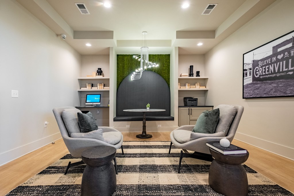 two chairs and a table in a living room with a tv