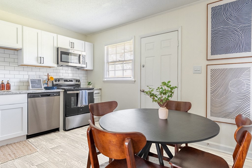 a kitchen and dining room with a table and chairs