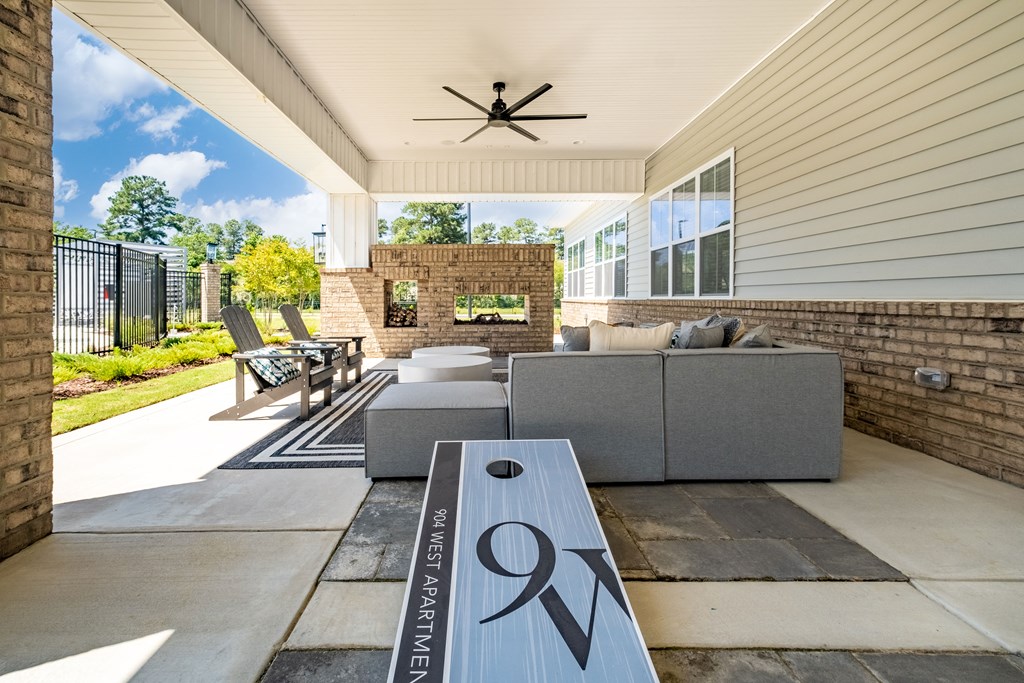 a covered patio with couches and a coffee table