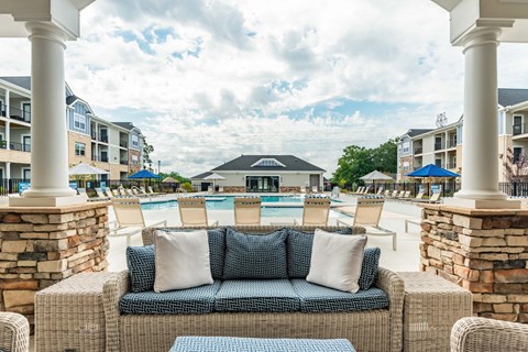 the preserve at ballantyne commons pool area with lounge chairs and a couch