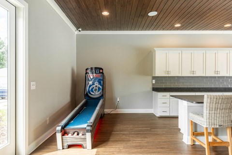 a game room with a pool table in the corner of a house