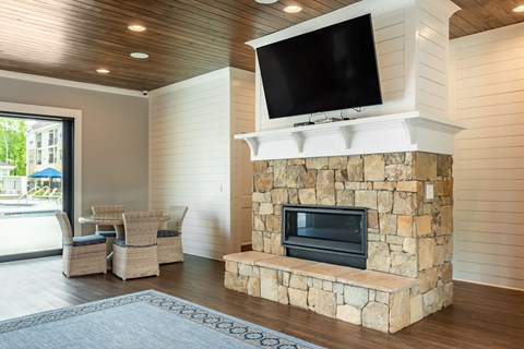 a living room with a fireplace and a tv on top of it
