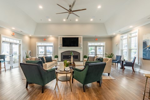 a living room with couches and chairs and a fireplace