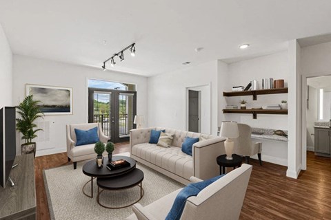 A living room with a white couch, a black coffee table, and a painting on the wall.
