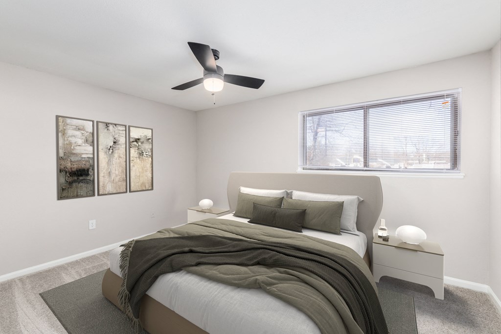 a bedroom with a bed and a ceiling fan