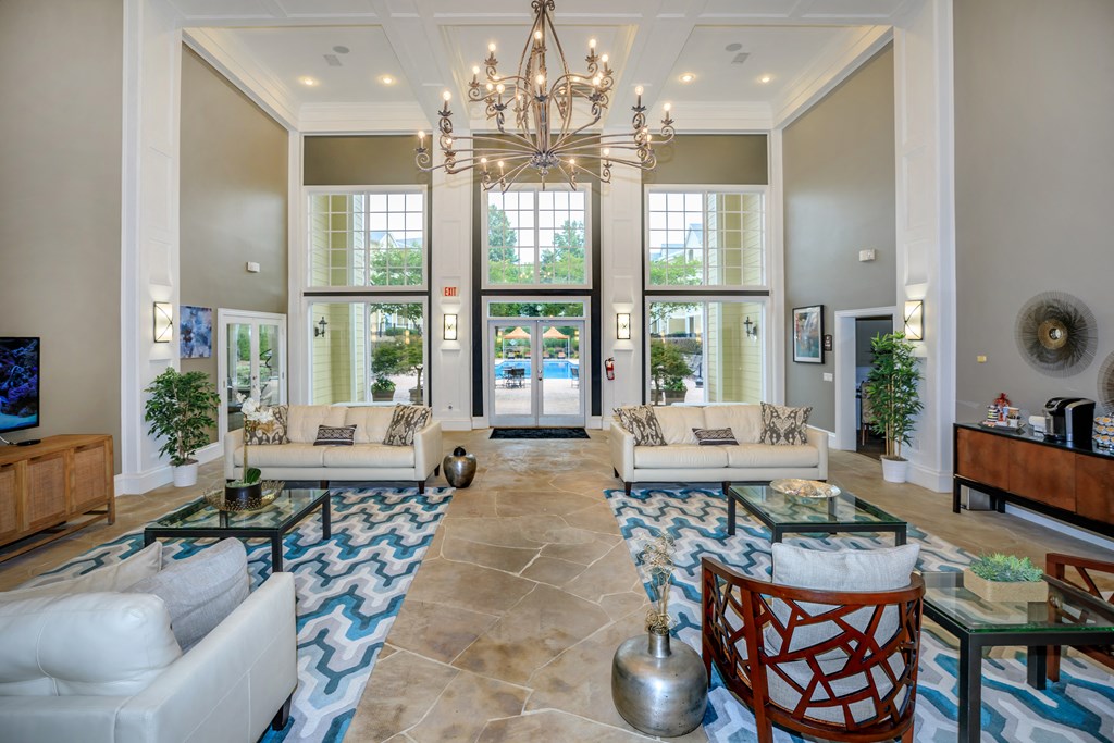 a large living room with couches and a chandelier