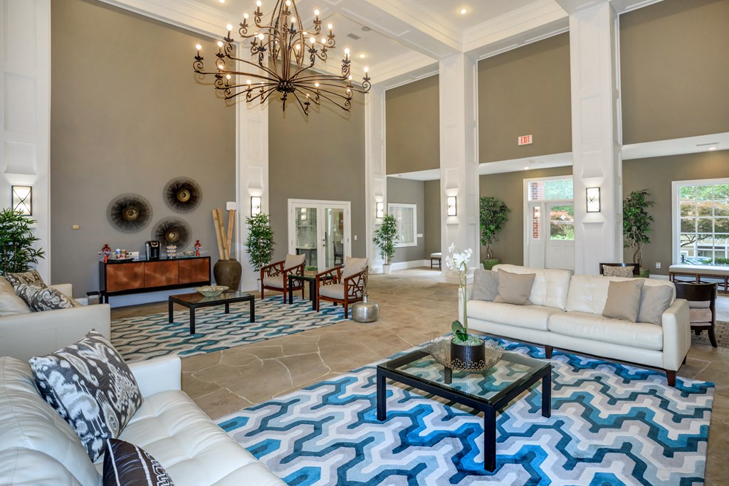 a living room with couches and a chandelier