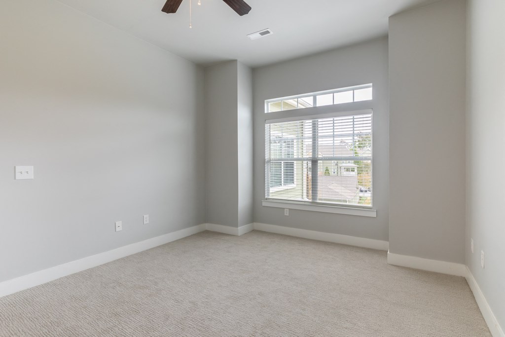an empty living room with a large window