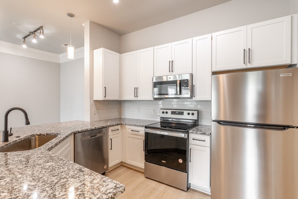 a kitchen with granite counter tops and stainless steel appliances
