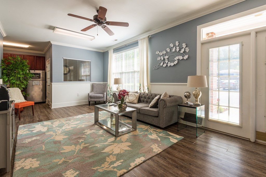 a living room with a couch and a ceiling fan