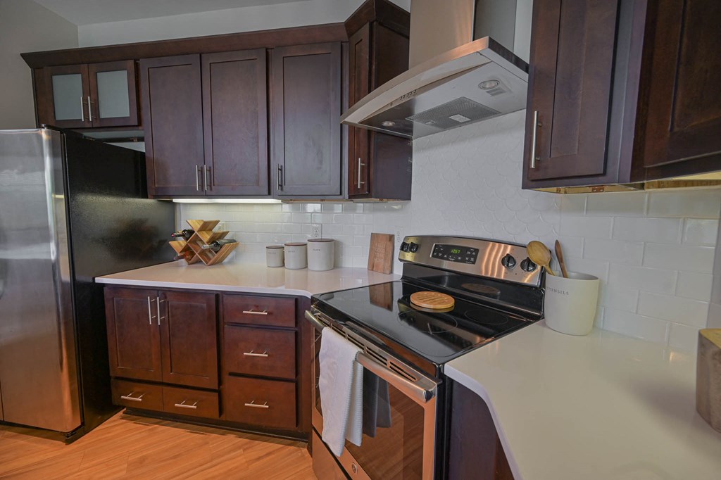 a kitchen with a stove and a refrigerator