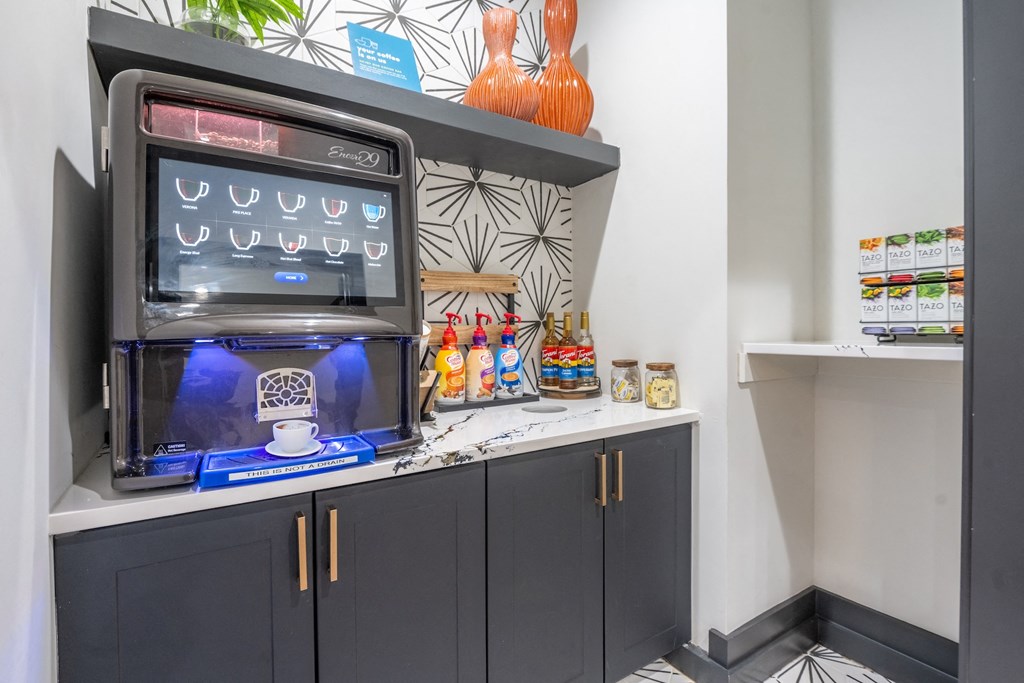 a beverage station with a coffee machine and drinks on a counter