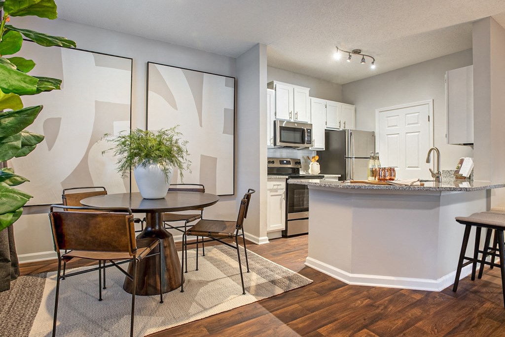 an open kitchen and dining room with a table and chairs