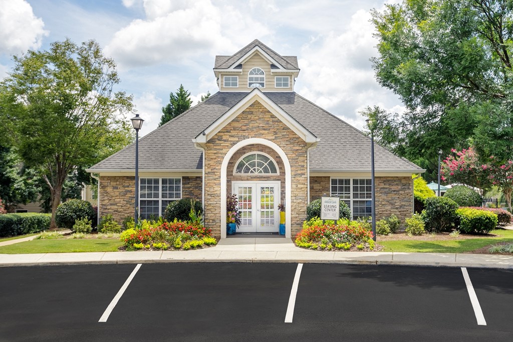 the front of a brick church with a white door and a lawn