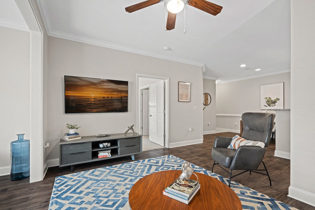 a living room with a couch and a chair and a coffee table
