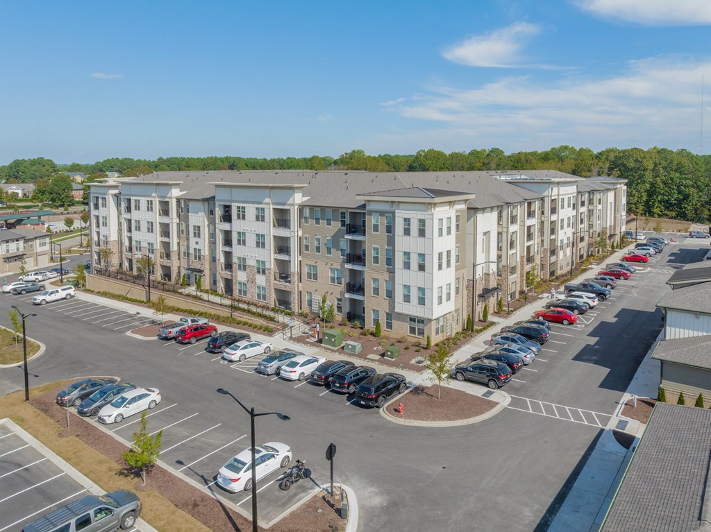 an aerial view of an apartment complex with a parking lot