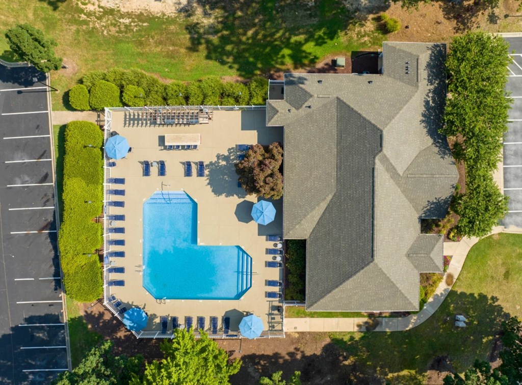 arial view of a house with a swimming pool and lawn