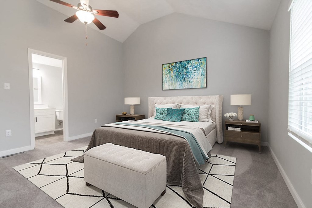 a bedroom with a bed and a ceiling fan