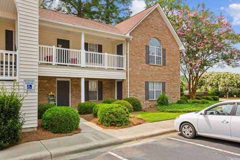 a white car parked in front of an apartment building