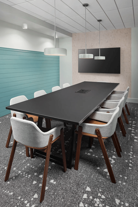 A conference room with a long table and chairs at Boardwalk at Research Park apartments in Huntsville, AL.