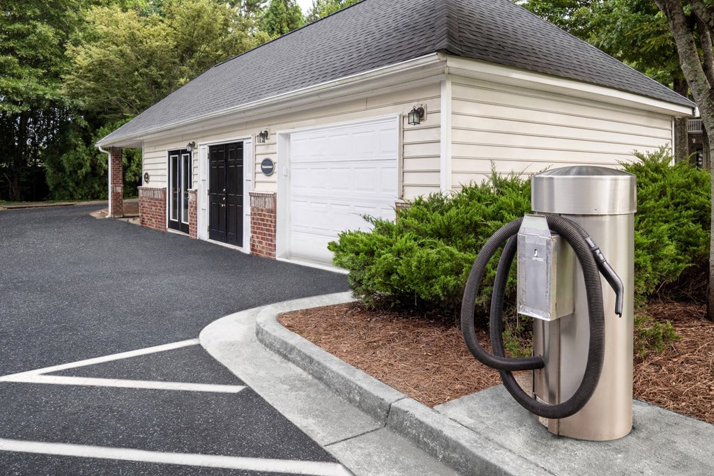a gas pump in front of a white building
