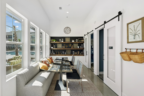 a living room with a long couch and a table with chairs
