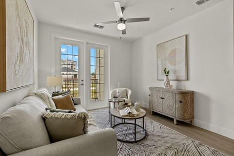 an open living room with a couch and a ceiling fan