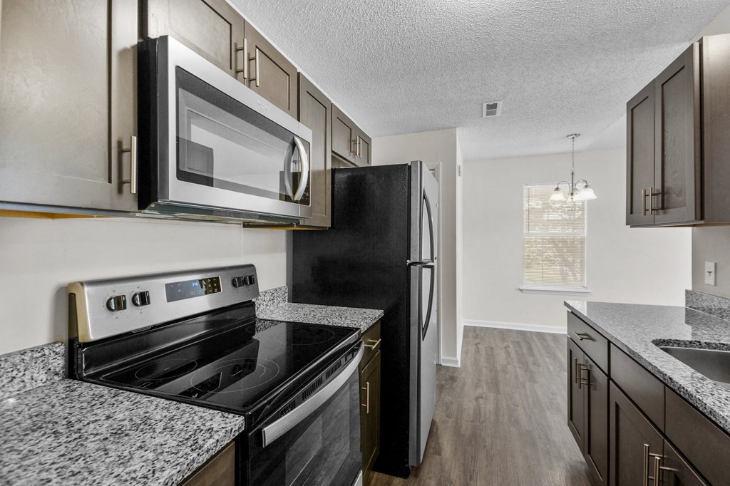 a kitchen with black appliances and granite counter tops