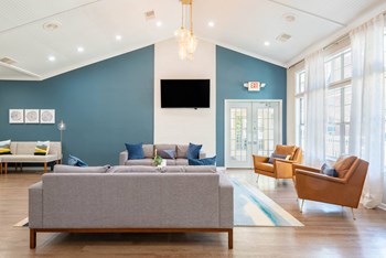 a living room with blue walls and a large window