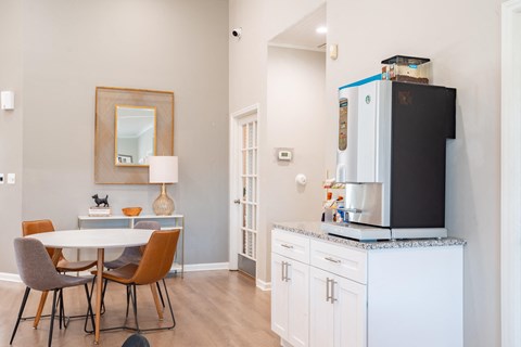 Amenities a dining area with a table and chairs and a refrigerator