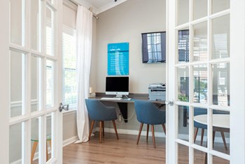 a desk with a computer and a monitor in a room with french doors - Photo Gallery 11