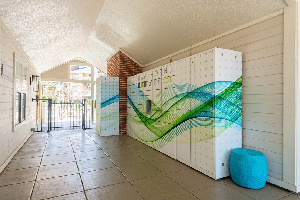 a hallway with white walls and a tiled floor with a blue stool in front of it