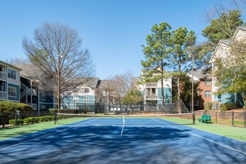 a tennis court at the whispering winds apartments in pearland, tx - Photo Gallery 29