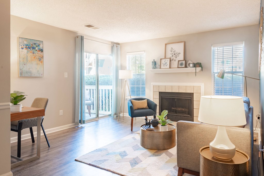 a living room with a fireplace and sliding glass doors