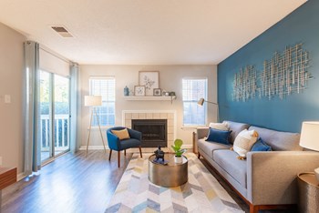 a living room with a blue accent wall and a fireplace - Photo Gallery 33