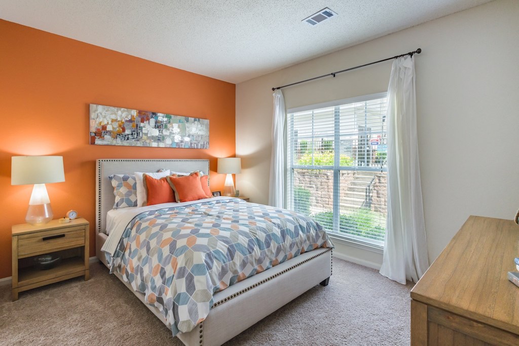 a bedroom with a bed and a window