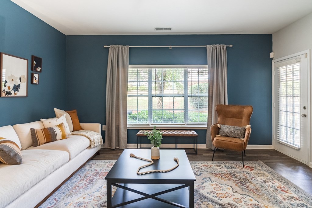 a living room with blue walls and a white couch