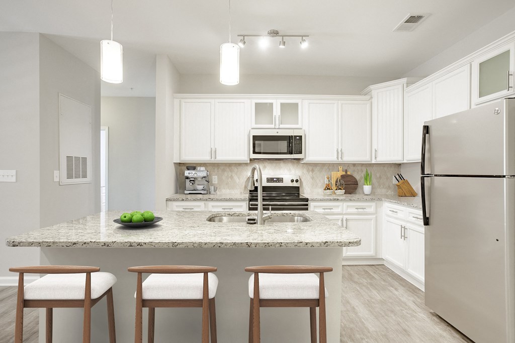 a kitchen with white cabinets and a granite counter top